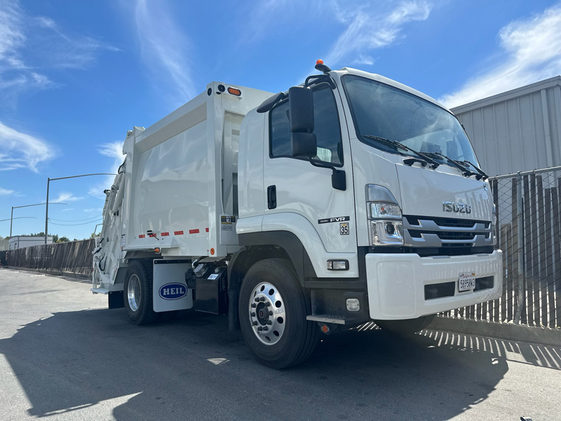 Isuzu FVR cab over rear loader refuse truck
